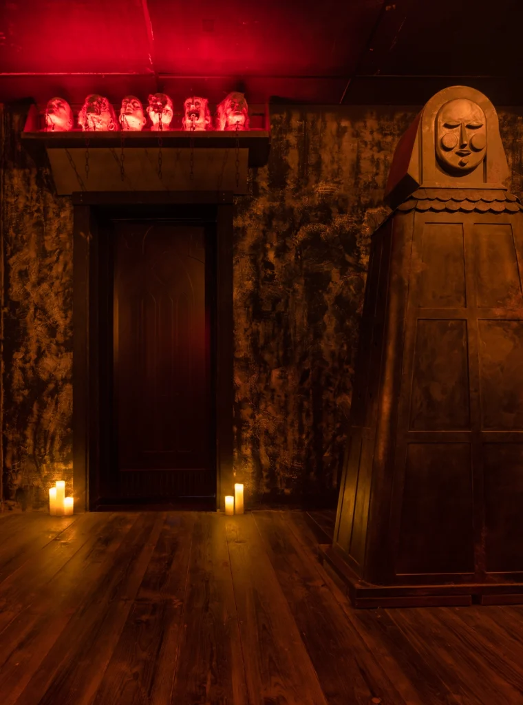 Spanish virgin puzzles with with light up heads puzzles in the background in Medieval Madness escape room