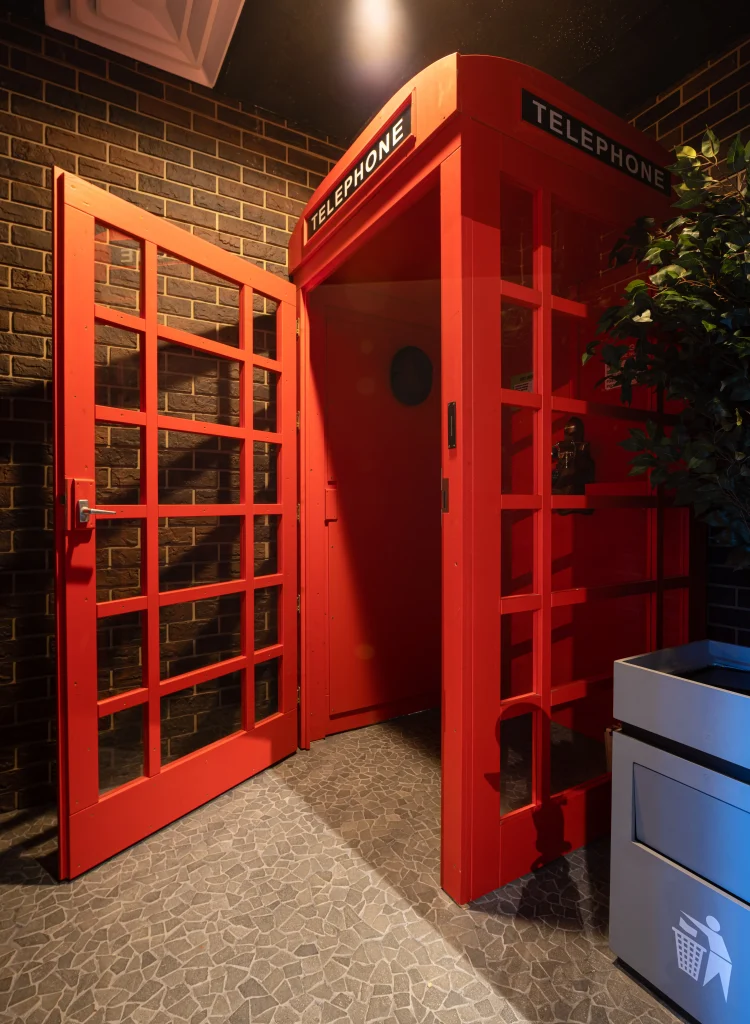 Firs chamber with a big red London phone booth puzzle in Red Wire escape room